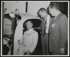 Senator Stephen Young, factory representative J. C. Burrett, and Senator Howard W. Cannon at flight simulator exhibit at the World Congress of Flight, Las Vegas, Nevada: photographic print