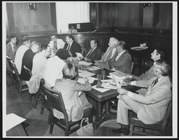 Howard Cannon sits at a table with a large group: photographic print