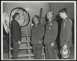 Dr. Sidney J. Leverett, chief of the School of Aerospace Medicine's Biodynamics Department briefing Howard Cannon on the Simulator: photographic print