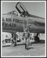 Howard Cannon walking away from a United States Air Force F-105D aircraft: photographic print