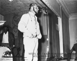 Frank Brockman speaking at a meeting concerning the Beatty Burro Races: photographic print