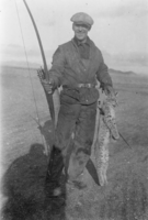 Jess Toles displays a bobcat taken with bow and arrow: photographic print