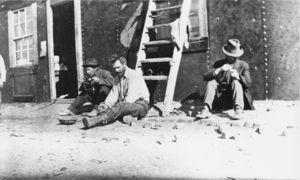 John Quincy "Jack" Lisle (identified in the center) at a prospector's cab: photographic print