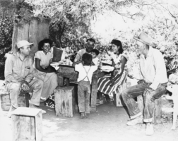 Roland Wiley and Elmer Bowman visit Harry and Mary Sackett, a Native American couple living on the Manse Ranch: photographic print
