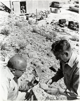 Art and Norman Revert examine ore specimens at the Boyd-Endseley Mining Company Mill: photographic print