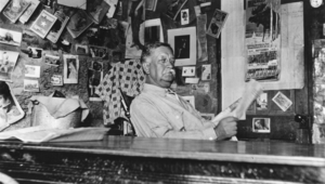 Josiah Irving Crowell in his dugout dwelling at his Chloride Cliff mine, Nevada: photographic print