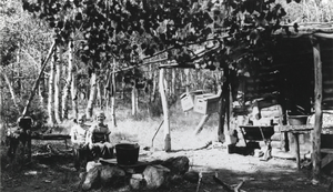 Dick and Gary Carver (identified from left to right) in front of the cabin on the Wardenot pasture, Nevada: photographic print