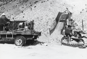 Robert "Bob" Wilson operating his triple-drum, slusher-feeding system: photographic print