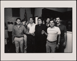 Members of the Nicaraguan Association of Las Vegas standing with a Catholic priest: black-and-white photographs
