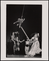 A traditionally dressed Mexican girl is cheered on by onlookers as she tries to break a swinging pinata at a fiesta in Las Vegas, Nevada: black-and-white photographs