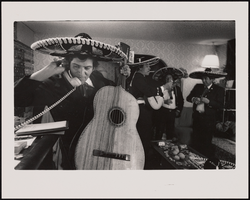 Manny Mandel, manager of Los Trobadores (one of the oldest for-hire mariachi groups in Las Vegas) talks on the phone during a pre-performance rehearsal in his home in Las Vegas, Nevada: black-and-white photographs