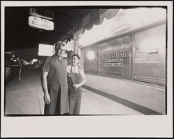 Rafael Montelongo Diaz and his wife, Josefa Fefa stand together outside their former restaurant, La Familia: black-and-white photographs