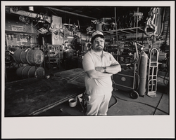 Henry Sanchez, owner-operator of Diamond Metal Works sheetmetal fabrication and welding shop, stands inside his Las Vegas, Nevada business: black-and-white photographs