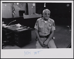 Chief Bailiff for District Court Judge John Mendoza Al Rivero posed in uniform: black-and-white photographs