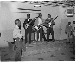 Photograph of a band performing on a small stage