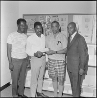 Set of photographs including Jo Mackey Summer Program, and NAACP receiving check from fraternity, 1970