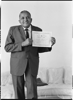 Set of photographs including Mr. Booker with certificate, Miss Eva Houston, Bob and others at 1706 Highland: image 001