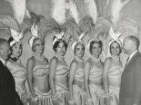Photograph of Harold Minsky posing with six of his showgirls, 1970-1979