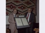 Senator Chic Hecht and unidentified man holding Public Law 100-275 (Nevada-Florida Land Exchange Authorization Act of 1988), Jun