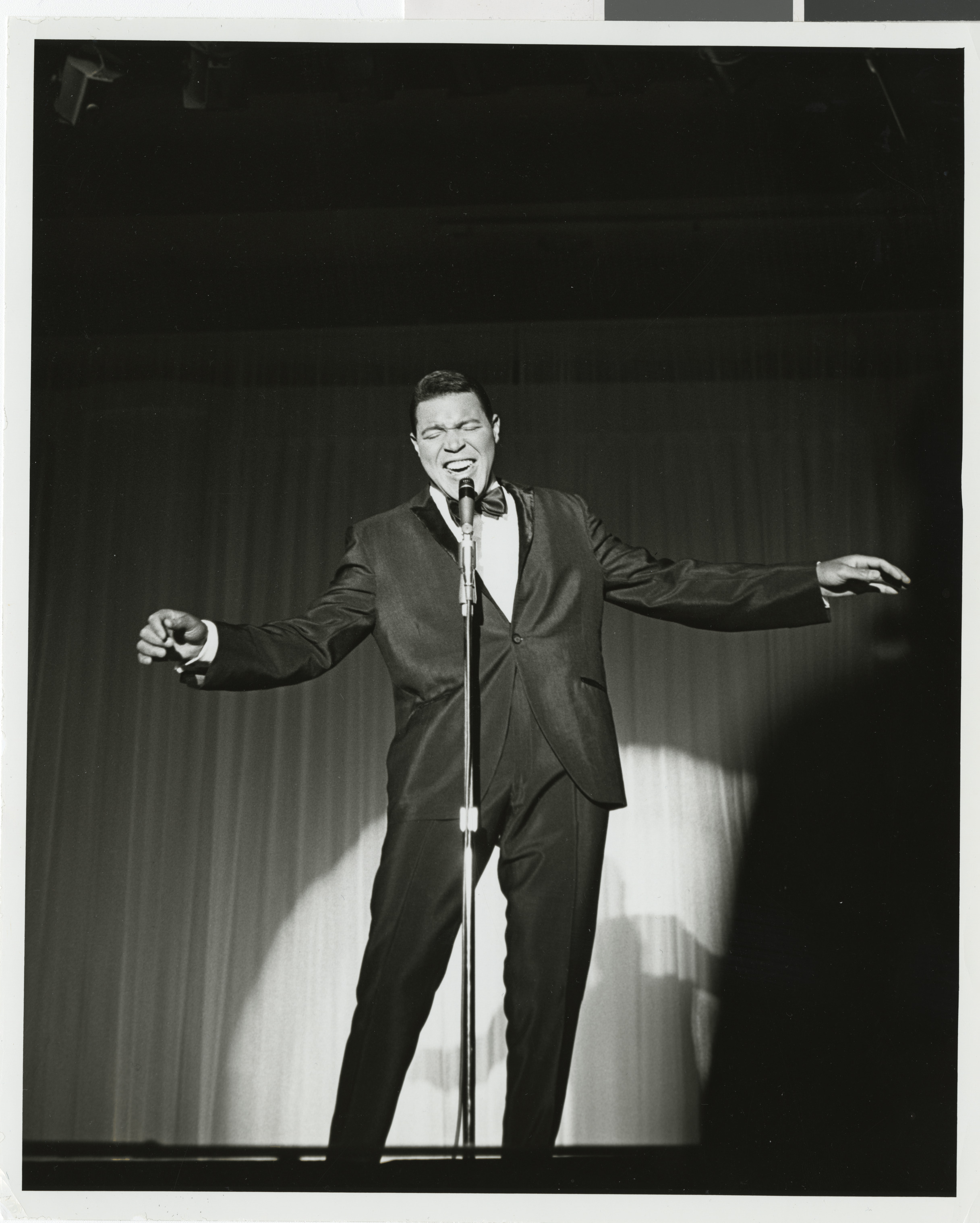 Photograph of Chubby Checker performing onstage at the Sands Hotel, August 1962