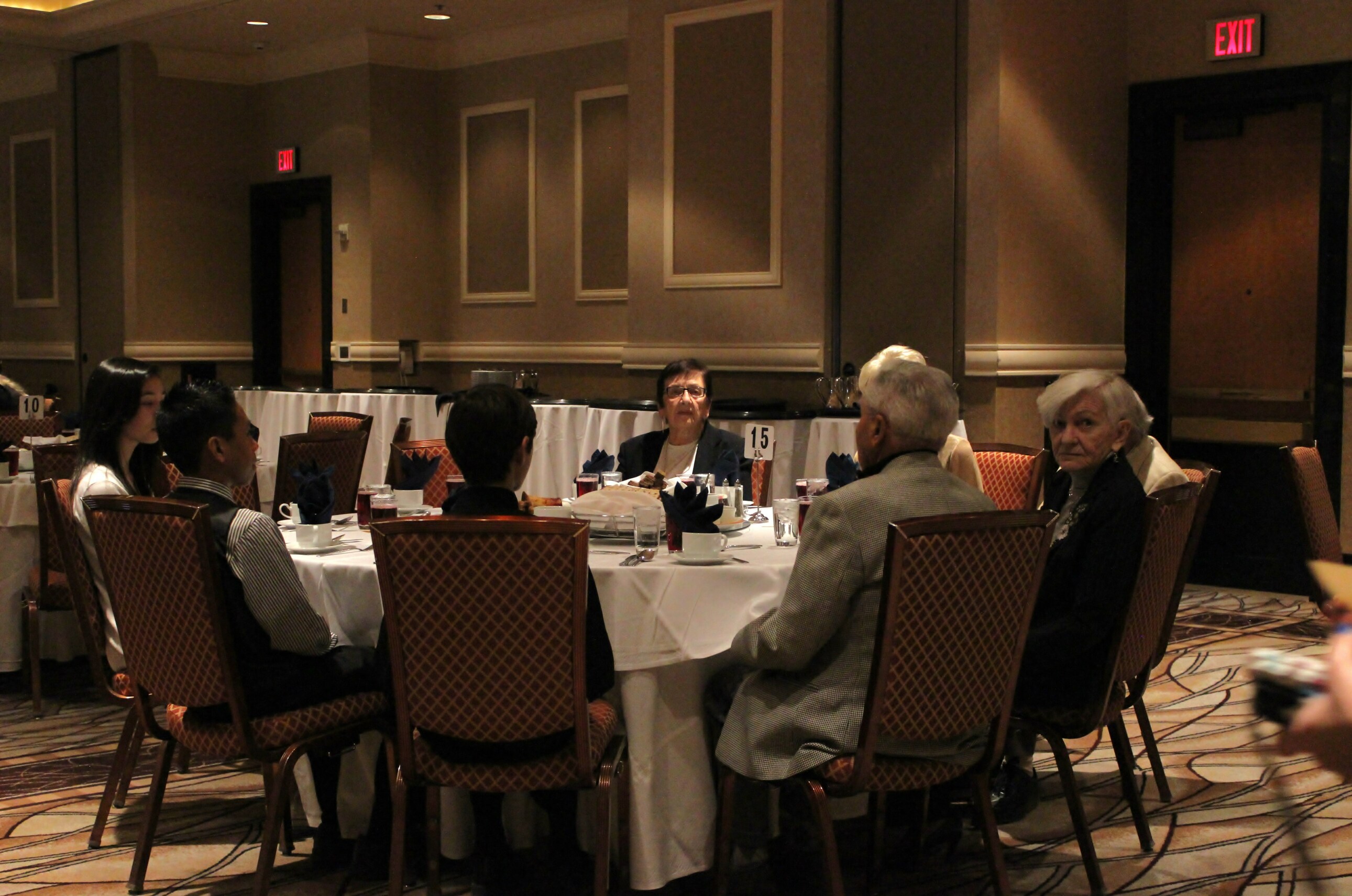 Survivors and students seated together waiting for Seder to start (photo by Jordan Kyle Hoffman)