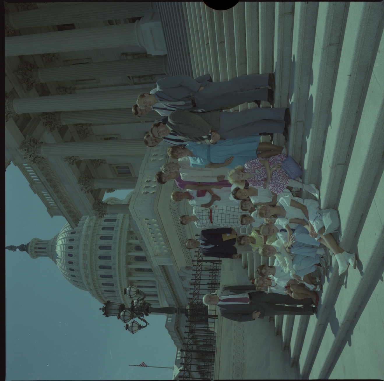 Film negative of group of people including Senator Chic Hecht standing on the Capitol steps, June 28, 1988