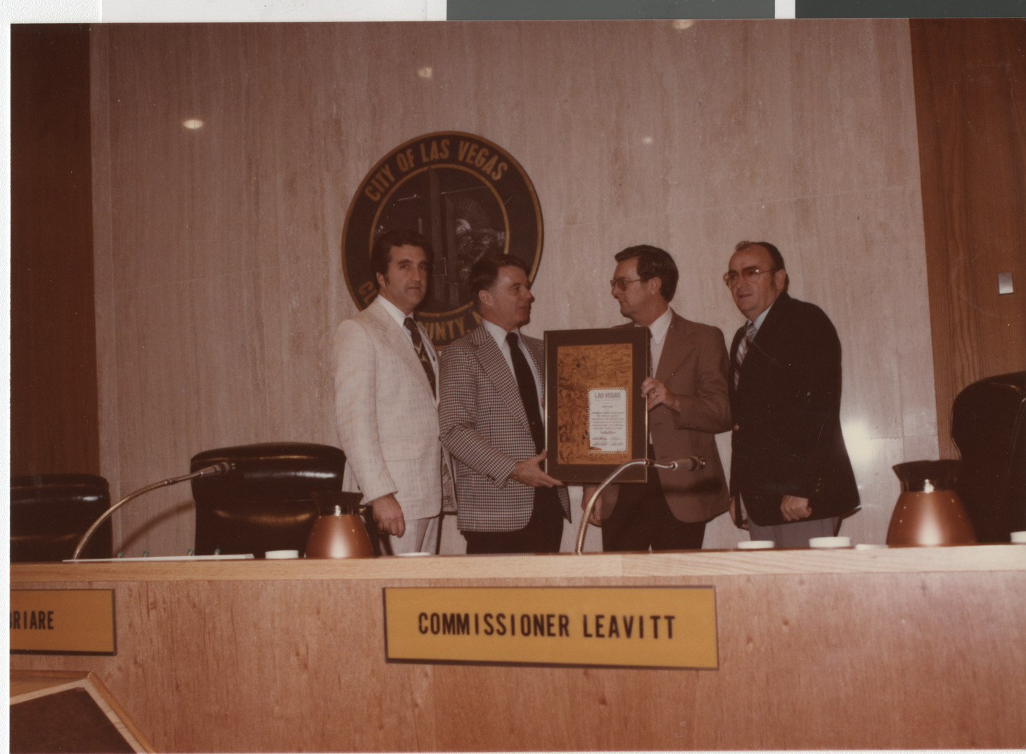 Photograph of Ron Lurie and others presenting plaque, circa 1978
