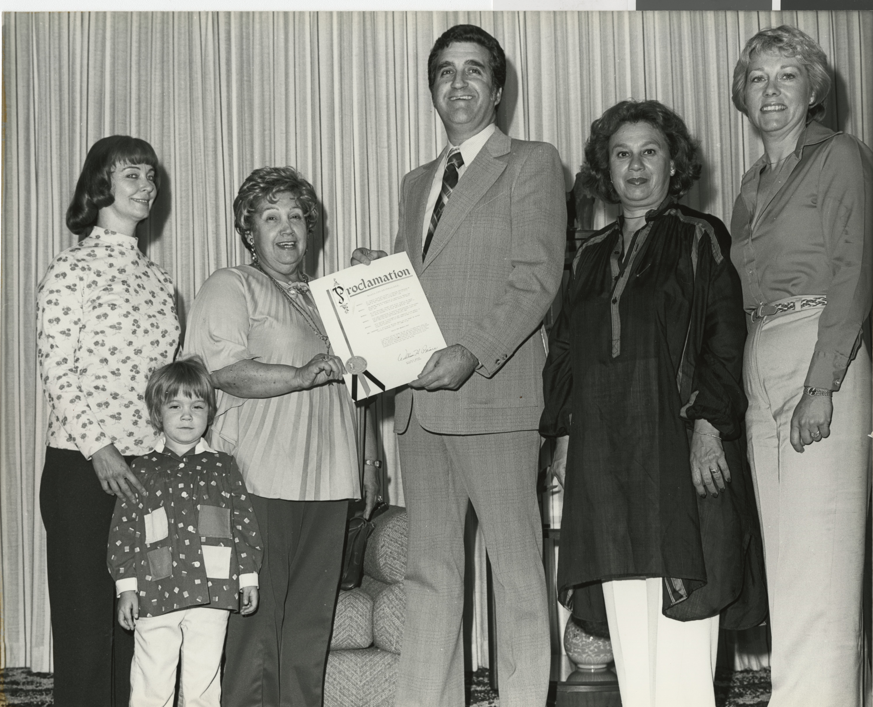 Photograph of Ron Lurie presenting a proclamation to a group, circa 1978