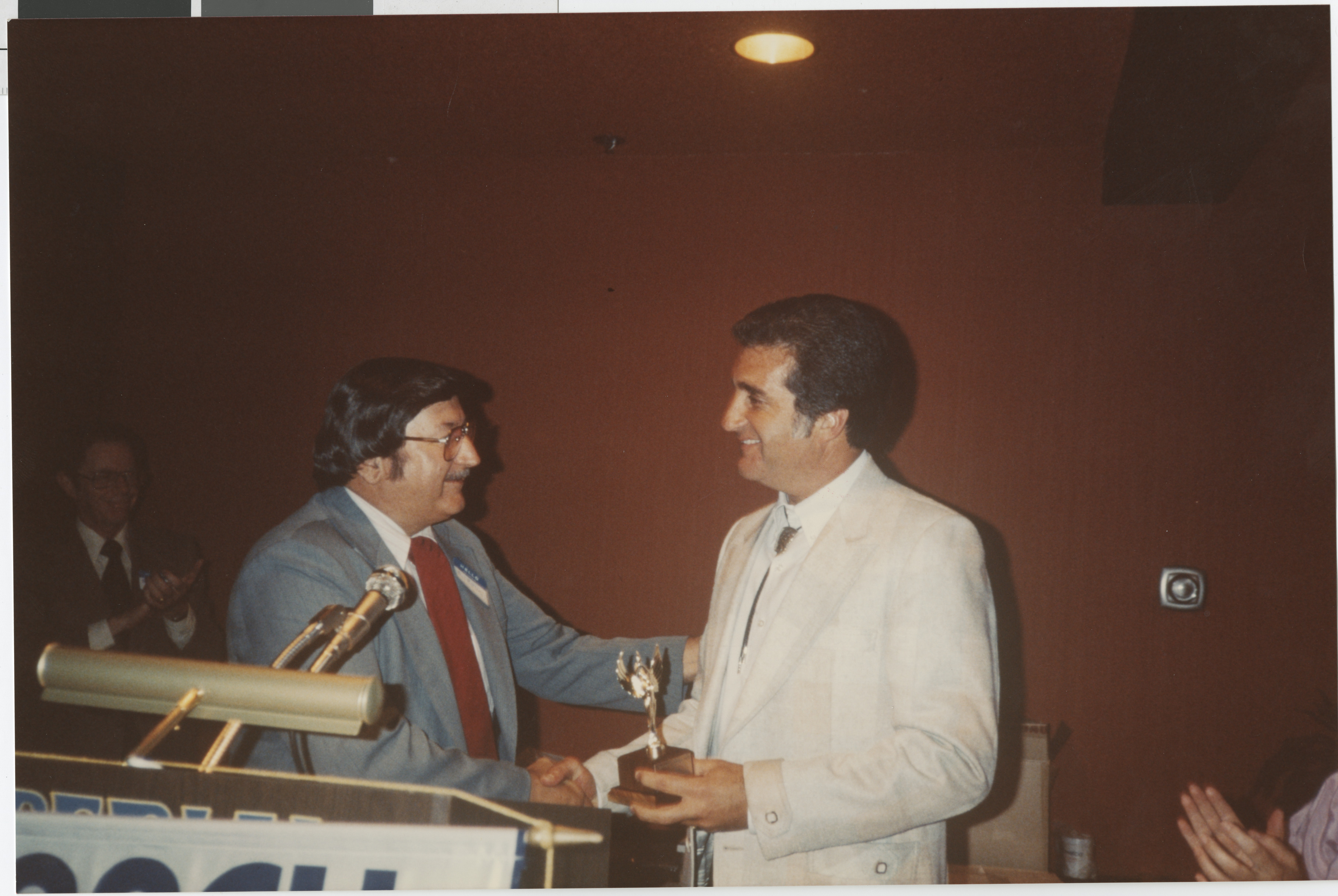 Photograph of Ron Lurie receiving a trophy