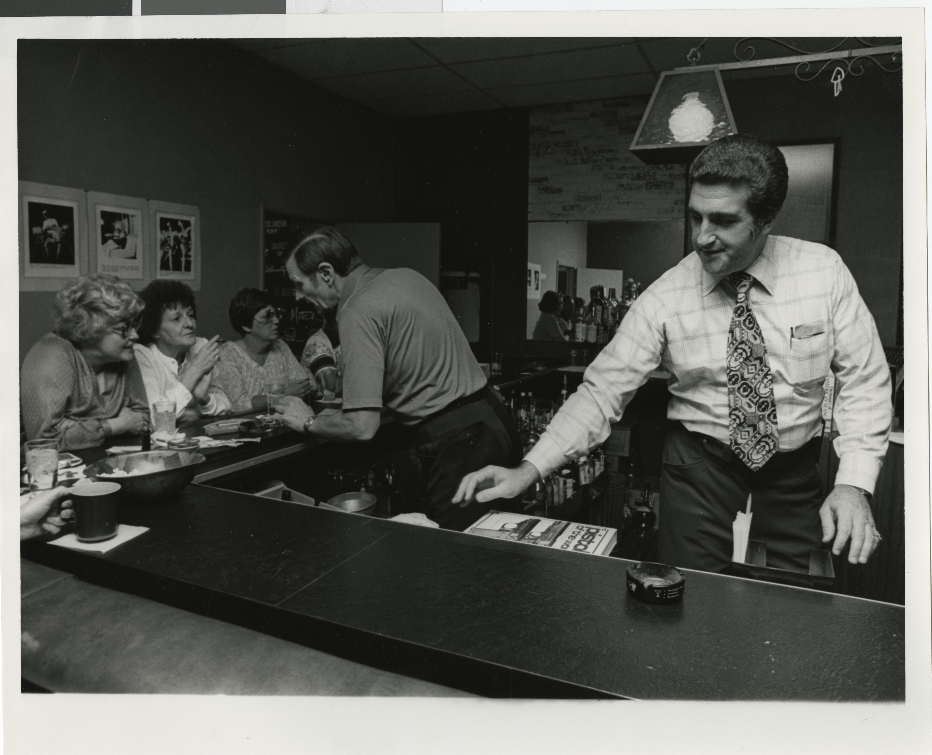 Photograph of Ron Lurie tending bar