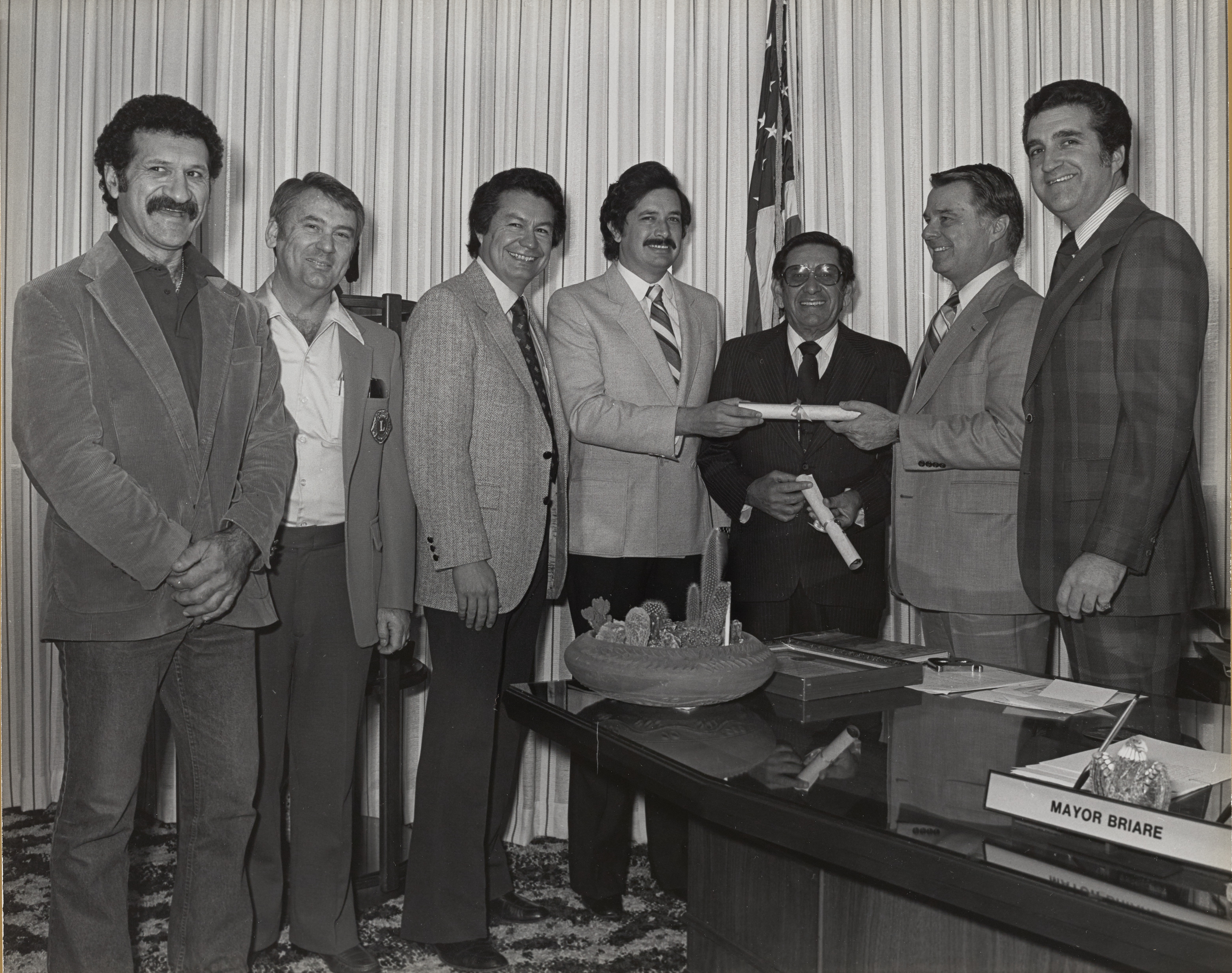 Photograph of Mayor Briare and Ron Lurie conferring scrolls