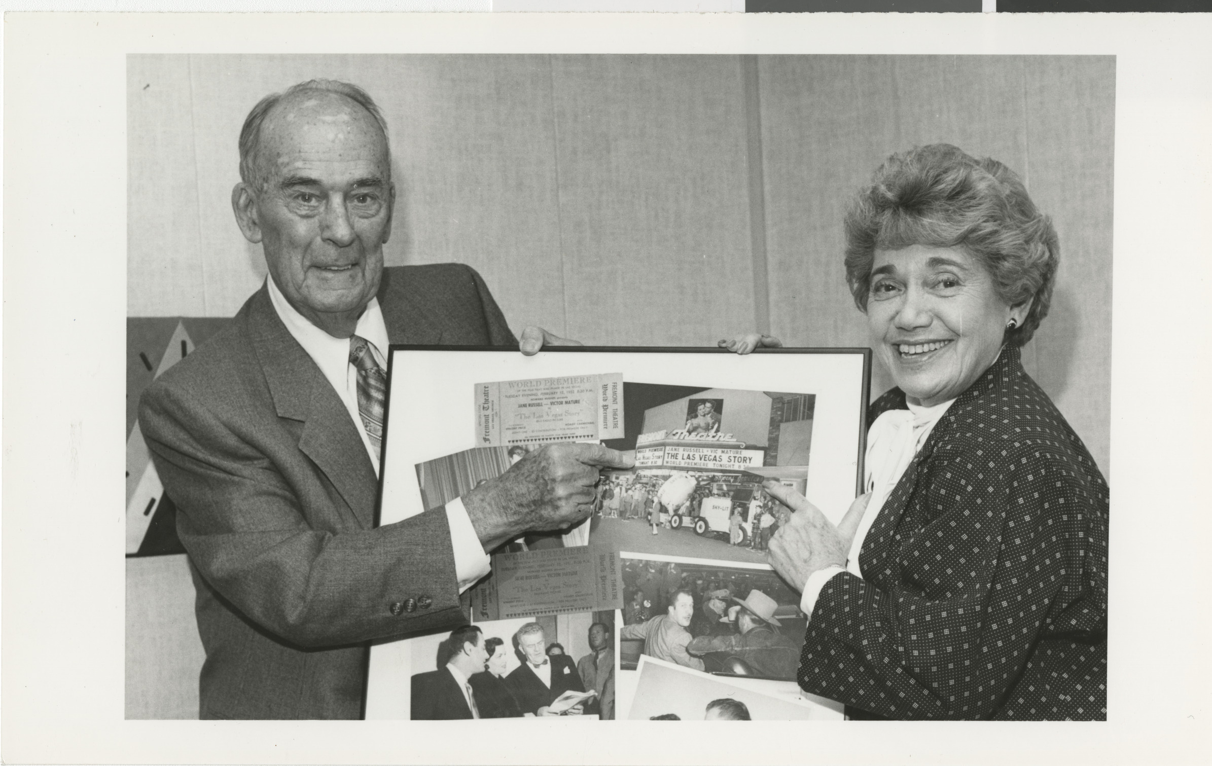 Photograph of Edythe Katz with Perry L. (?) with collage at dedication of the Lloyd Katz Honors Lounge at UNLV