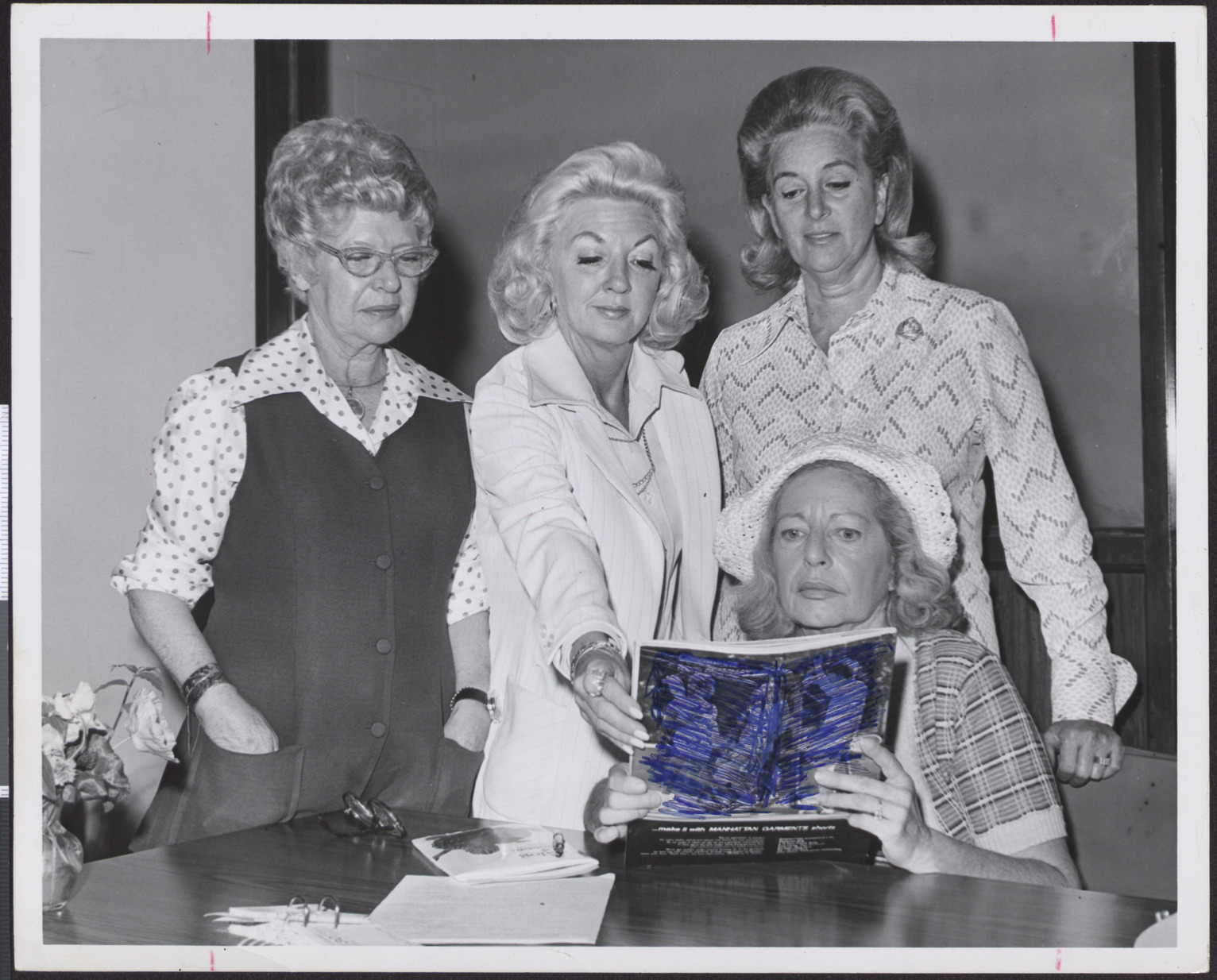 Photograph of Hadassah members looking at a magazine
