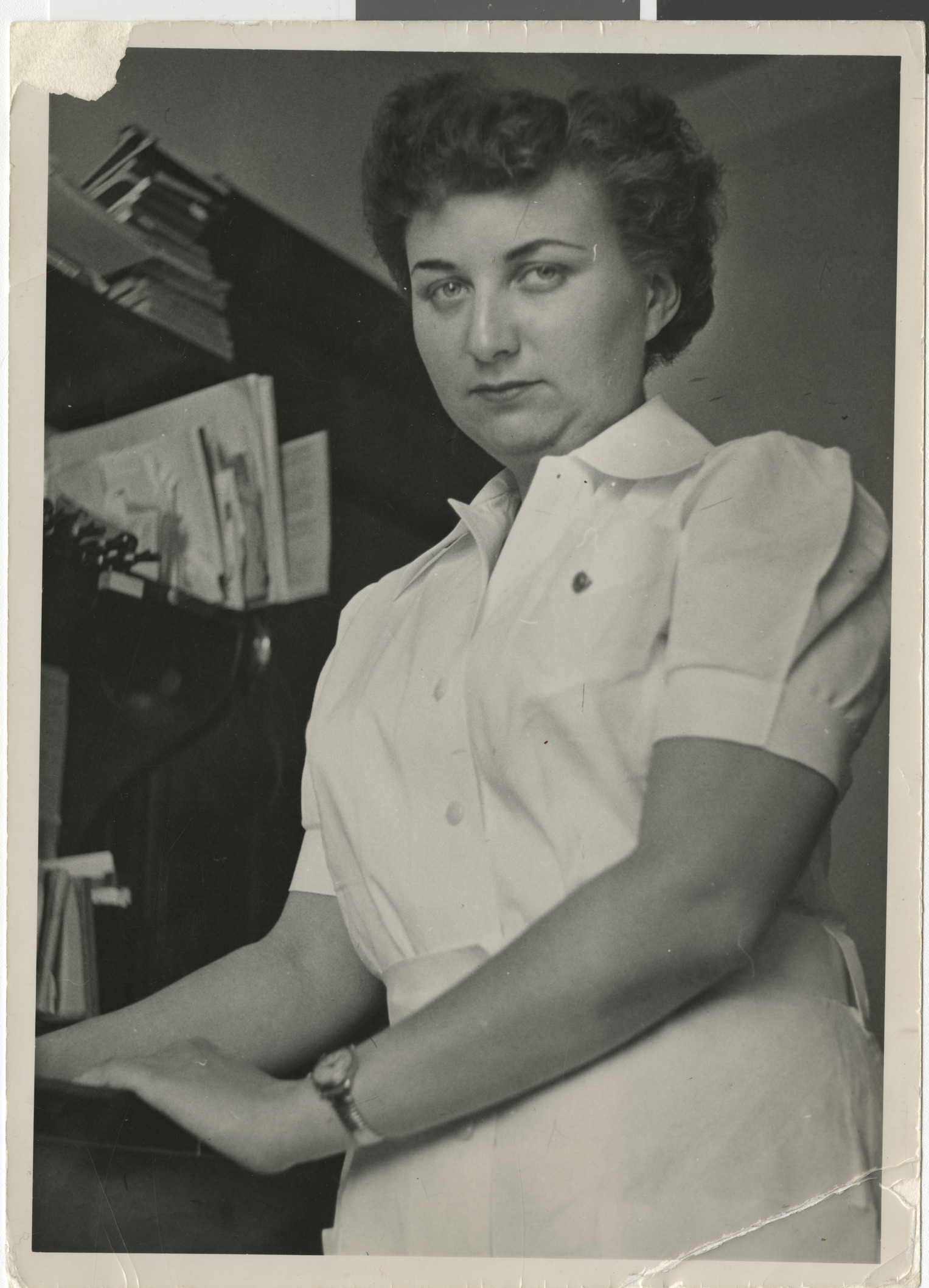 Photograph of Adele Baratz standing in an office, circa 1947